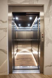 an elevator in a building with a shiny metal door at Trikala River House in Tríkala