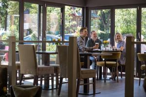 a group of people sitting at a table in a restaurant at Nether Abbey Hotel in North Berwick
