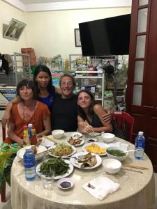 a group of women sitting around a table with food at Tám Thọ homestay in Tân Hiệp
