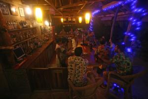 a group of people sitting at a bar at JJS BACKPACKERS VILLAGE in Siquijor