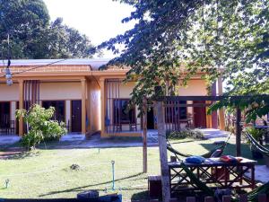 a building with a tree in front of it at Moon By Night in Don Det