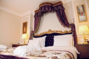 a bedroom with two beds with a large headboard at GLK PREMIER Sea Mansion Suites & Spa in Istanbul