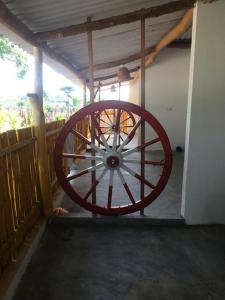 a large red wagon wheel sitting in a garage at Beach Lagoon Parans in Arugam Bay