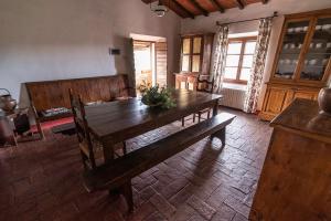 una sala da pranzo con tavolo e sedie in legno di Agriturismo La Fontaccia a Montiano