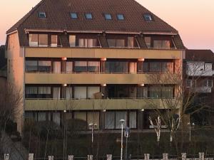 a large apartment building with a brown roof at Apartment Enjoy in Büsum