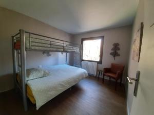 a bedroom with a bunk bed and a chair at Holiday home De la Corniche in Annecy