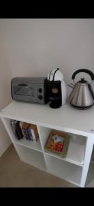 a white shelf with a tea pot on top of it at Trenasse in Marsala