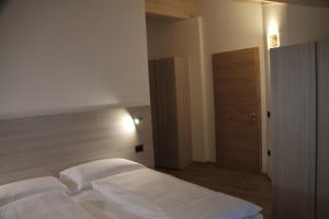 Posteľ alebo postele v izbe v ubytovaní MOUNTAIN RESORT Appartamenti