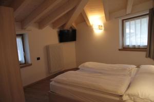 Posteľ alebo postele v izbe v ubytovaní MOUNTAIN RESORT Appartamenti