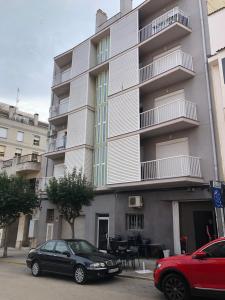 two cars parked in front of a building at Apartamento Constancia in Sant Carles de la Ràpita