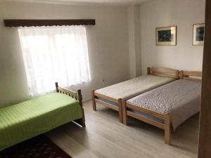 a bedroom with two beds and a window at Lydia Center Apartment in Veles