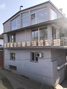 a house with a balcony on the side of it at Lydia Center Apartment in Veles
