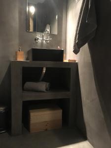 a bathroom with a vanity with a sink and a mirror at Traditional Village House in Tílisos