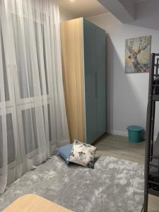 a bedroom with a pillow on the floor next to a cabinet at Apartament Miedziany in Szczyrk