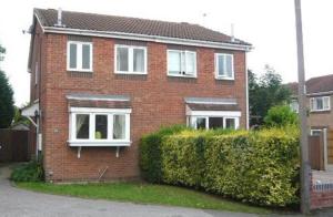 a red brick house with white windows and a hedge at Hatfield - Large Private Garden & Parking - 2 Bedroom House - Very Quiet Cul De Sac Location in Doncaster