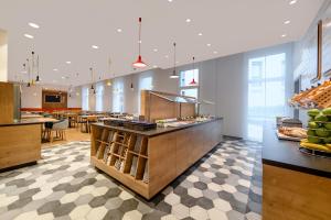 a cafeteria with a counter with food on it at Holiday Inn Express - Regensburg, an IHG Hotel in Regensburg