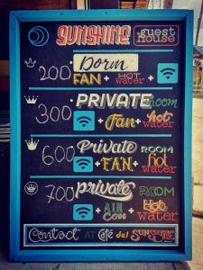a chalkboard sign with different signs on it at Cafe del sunshine in Ko Chang