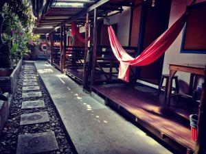 a house with a red hammock hanging from it at Cafe del sunshine in Ko Chang