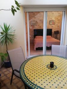 a room with a table and chairs and a bed at Villa Majorelle City Center in Agadir