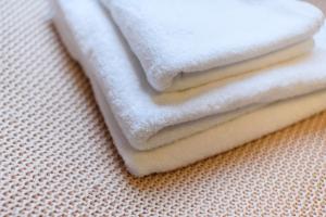 two white towels sitting on top of a table at City Retreat, 2 Bed House with Cloudstream Hot Tub in Cardiff +42 photos
