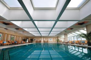 a swimming pool in a hotel with a ceiling at Sunworld Dynasty Hotel Beijing Wangfujing in Beijing