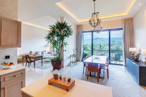 a kitchen and living room with a table and a dining room at Gran Melia Arusha in Arusha