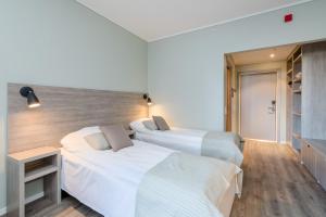 Postel nebo postele na pokoji v ubytování Grand Hotel Egersund
