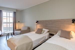 Postel nebo postele na pokoji v ubytování Grand Hotel Egersund
