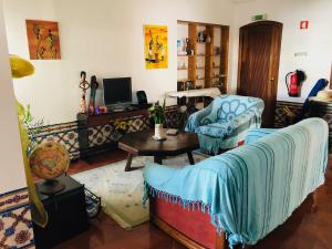 a living room with a couch and a tv at Maria Guest house in Albufeira