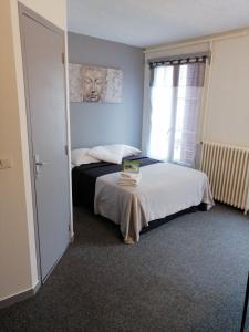 - une chambre avec un lit et une table dans l'établissement le relais, à Fontenay-Trésigny