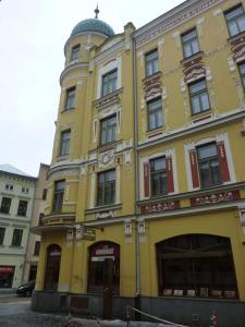 a yellow building with a dome on top of it at Grandhotel Garni in Jihlava