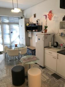 a kitchen with a table and a small table and a refrigerator at Leptir in Zagreb