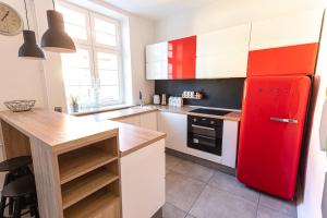 a kitchen with a red refrigerator and a counter at Republika Kopernika Apartment in Toruń
