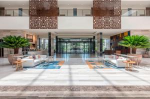 a lobby with couches and tables in a building at Gran Melia Arusha in Arusha