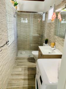 a bathroom with a shower and a toilet and a sink at Loft La ISLA in Playa Blanca