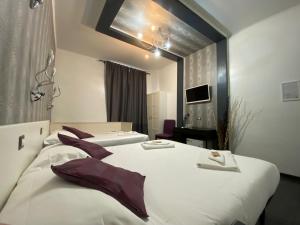 a hotel room with two beds and a mirror at The Place In Rome Guest House in Rome