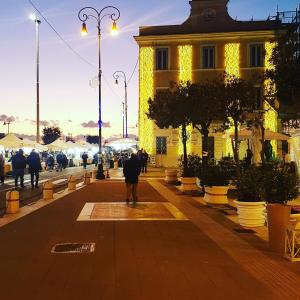 a person walking down a street in front of a building at la Dimora del Borgo in Fiumicino