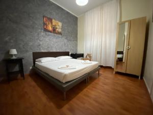 a bedroom with a large bed with white sheets at The Place In Rome Guest House in Rome