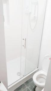 a bathroom with a shower and a toilet at The 55 in Enfield