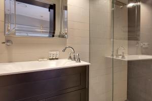 a bathroom with two sinks and a glass shower at Explore the Blue Mountains on foot in Katoomba
