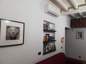 a living room with a black and white picture on the wall at House Orizzonte - Casa Bianca in Genoa