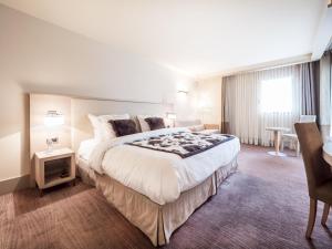 Postel nebo postele na pokoji v ubytování Hôtel Le Pré Carré