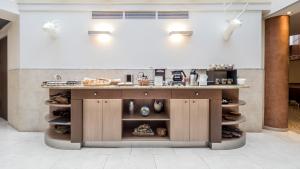 a kitchen with a counter with food on it at Hôtel Le Pré Carré in Annecy +7 photos