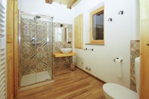 a bathroom with a glass shower and a sink at Cascina Bucolica in Alpignano