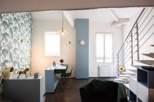 a living room with a staircase and a desk at Maison triplex JJ - Ecrin verdoyant au coeur de Lyon in Lyon