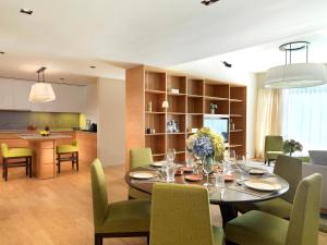 a dining room and kitchen with a table and chairs at Lanson Place Bukit Ceylon in Kuala Lumpur