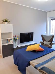 a bedroom with a large bed with a tv on it at Suite Rent Milan 2 in Milan
