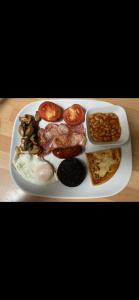 a plate of food with eggs meat beans and bread at Fox House Thirdpart Farm in Beith