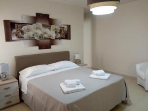 a bedroom with a bed with two towels on it at Residence Agave Lampedusa in Lampedusa