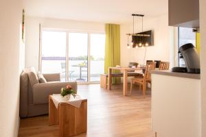 a living room with a kitchen and a dining room at Ferienhof Haas in Friedrichshafen